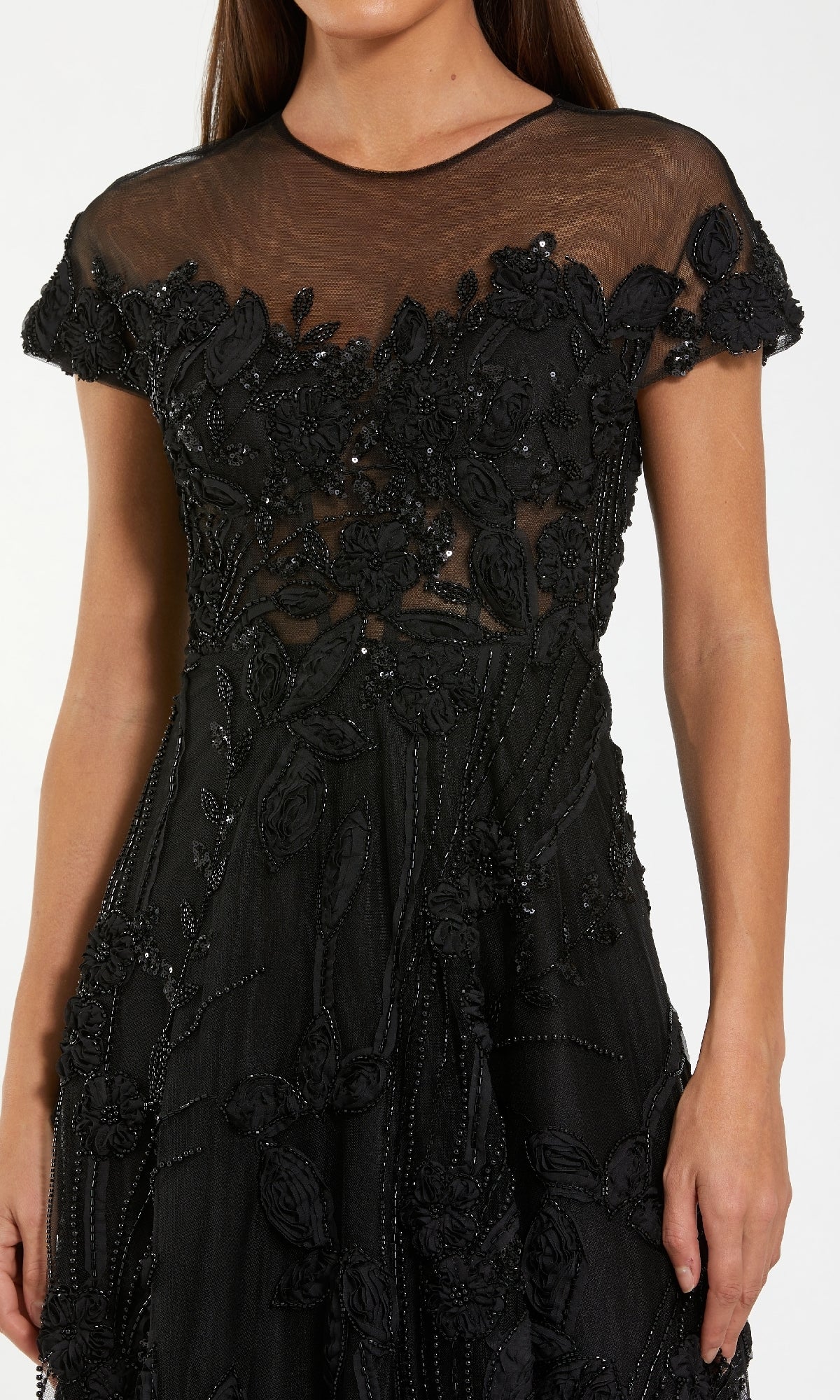 A woman wearing the Cap-Sleeve Black Formal Dress: Mac Duggal 69003, featuring floral embroidery, beaded details, sheer fabric, short sleeves, and a fitted waistโa stunning choice for formal evenings.